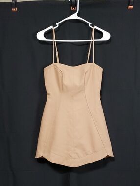 Beige Sleeveless Corset-Style Mini Dress With A Scalloped Hem.